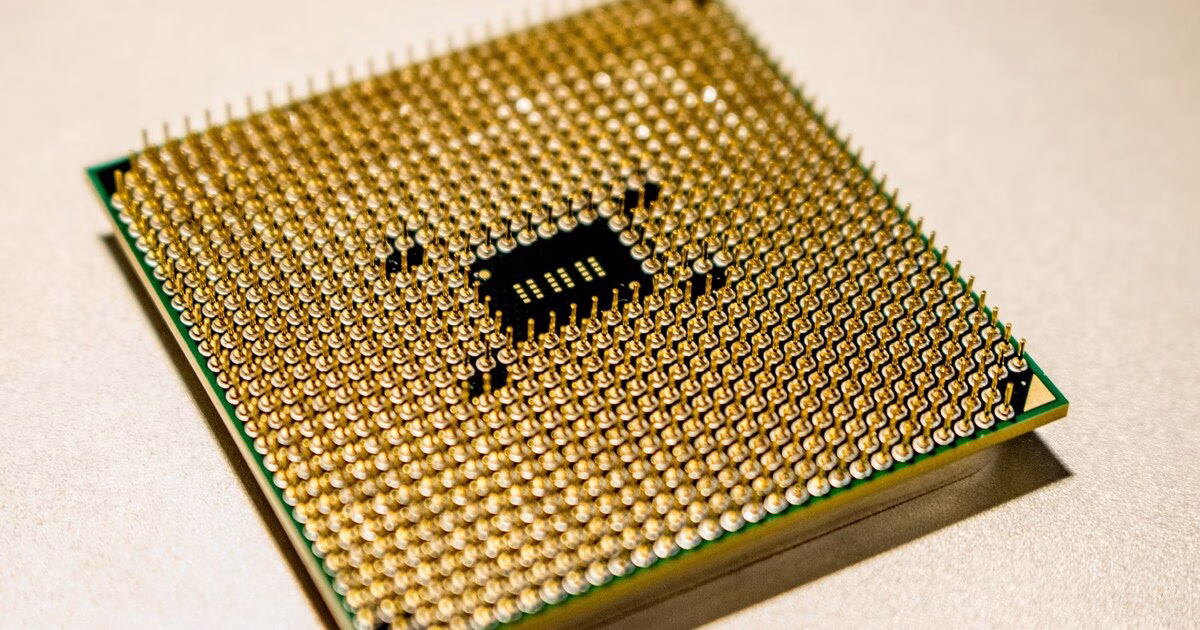 Close-up of a computer processor's gold connector pins