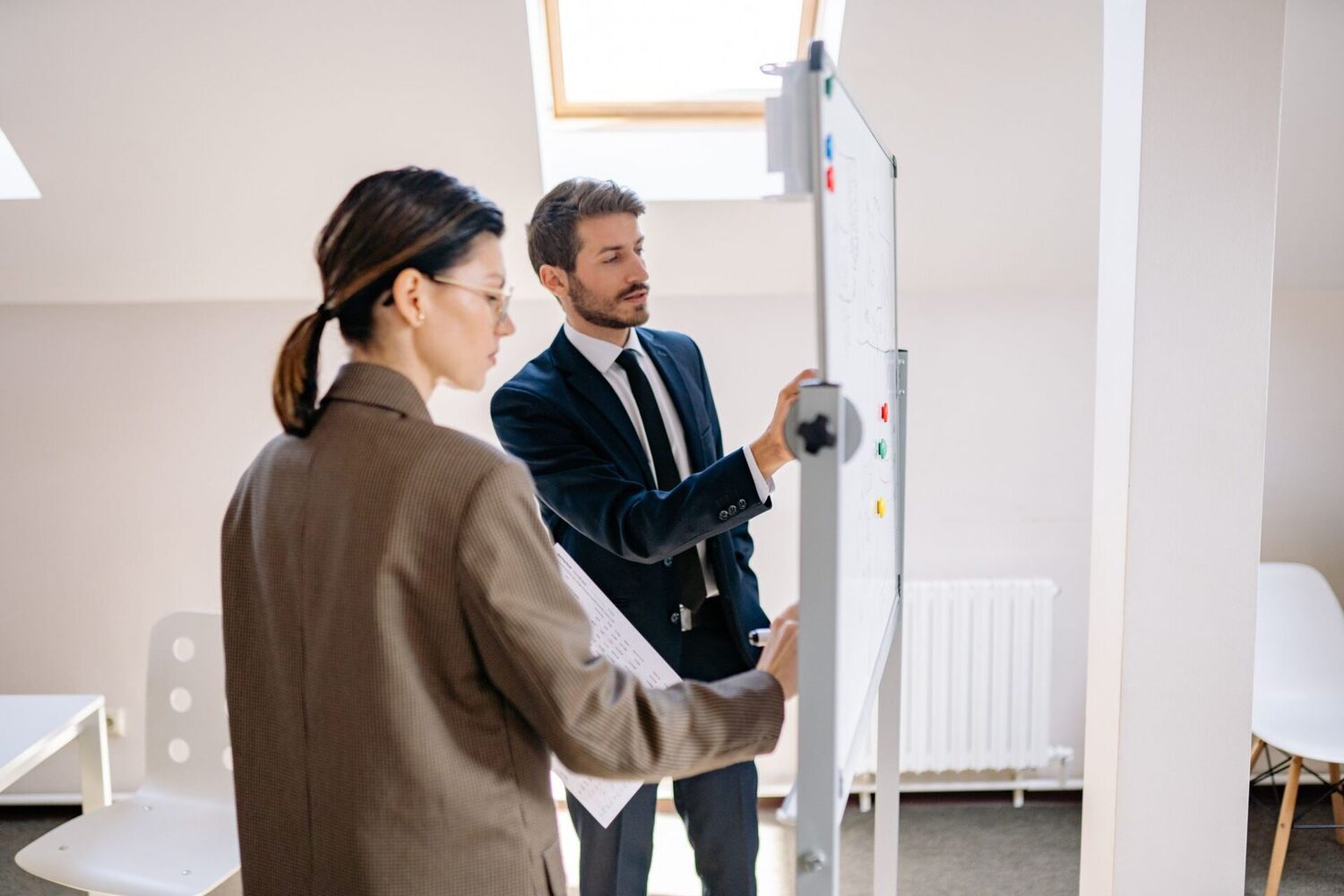 Digital marketing strategy session — two specialists planning at a whiteboard