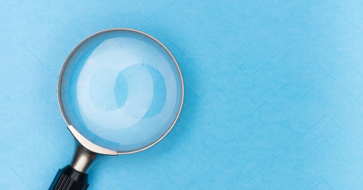 Magnifying glass on a blue background