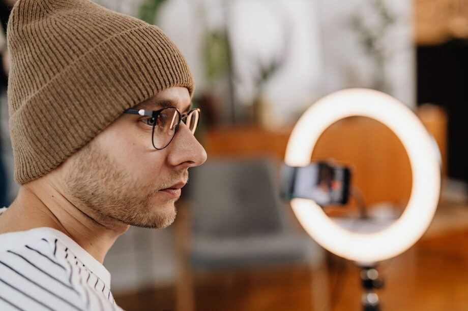 Social media content creation — a creator filming video with a ring light