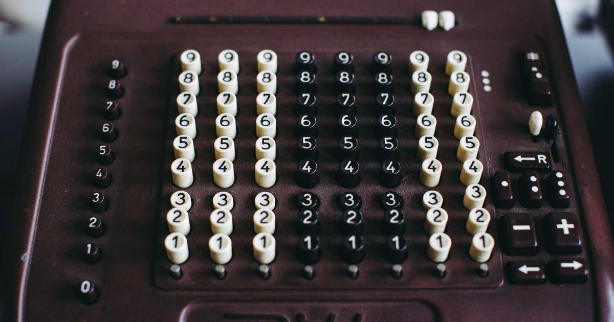 Close-up of a vintage mechanical calculator, echoing the decades-old panic that new tools would make us stupid — now aimed at AI