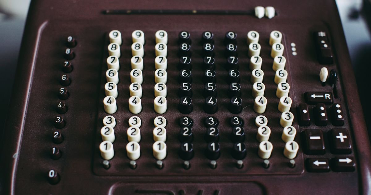 Close-up of a vintage mechanical calculator, echoing the decades-old panic that new tools would make us stupid — now aimed at AI